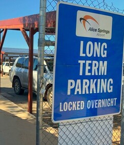 A board showing the Long Term Car Park sign at the gate of a parking lot